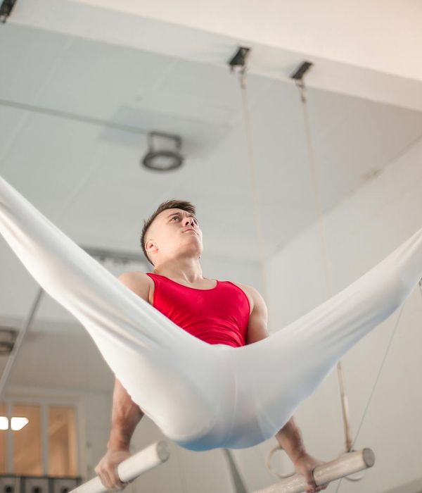 Man performing a strength exercise with focused determination in a modern gym.
